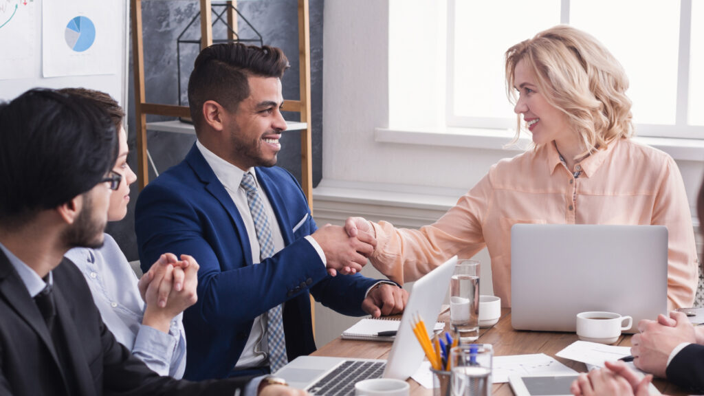 Marketing leader congratulates a team member