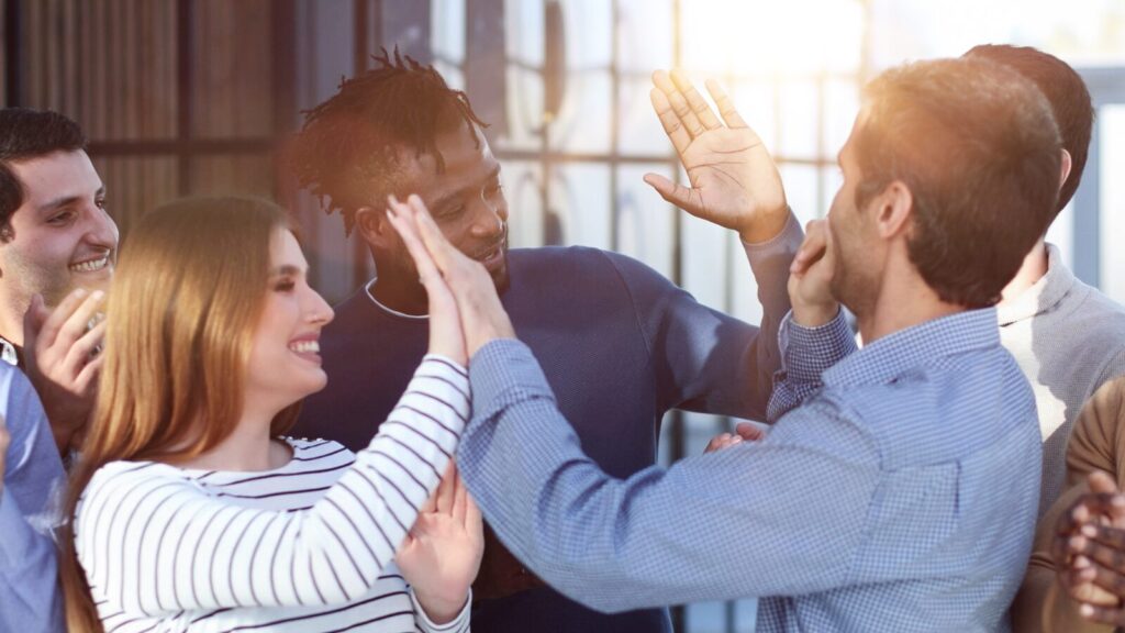 Customer success a group of professionals high five each other