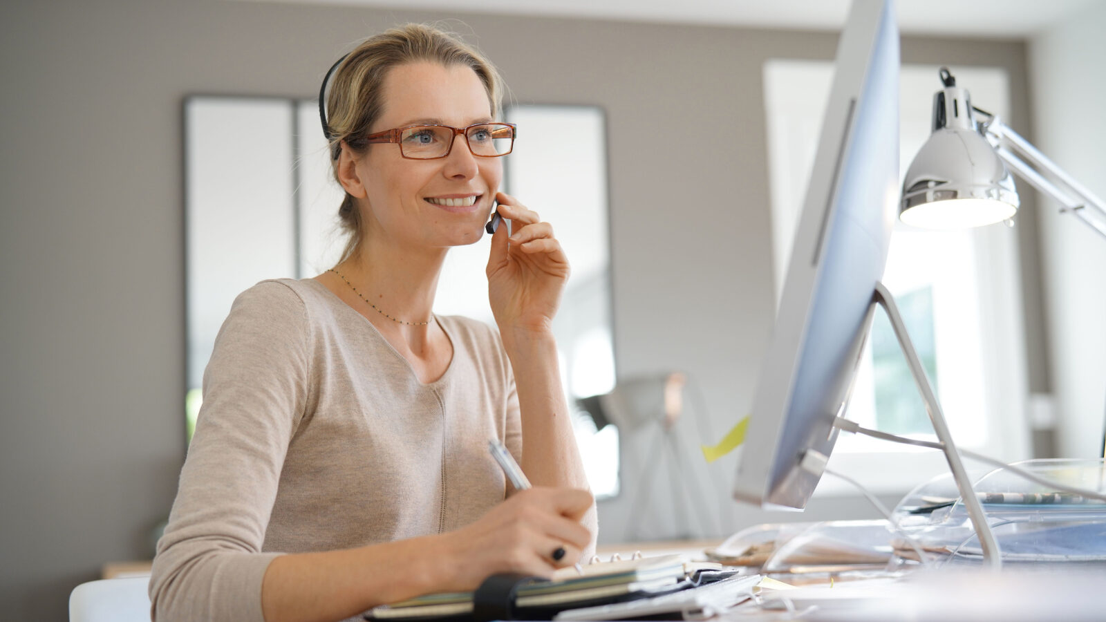 Smiling saleswoman working from remote office