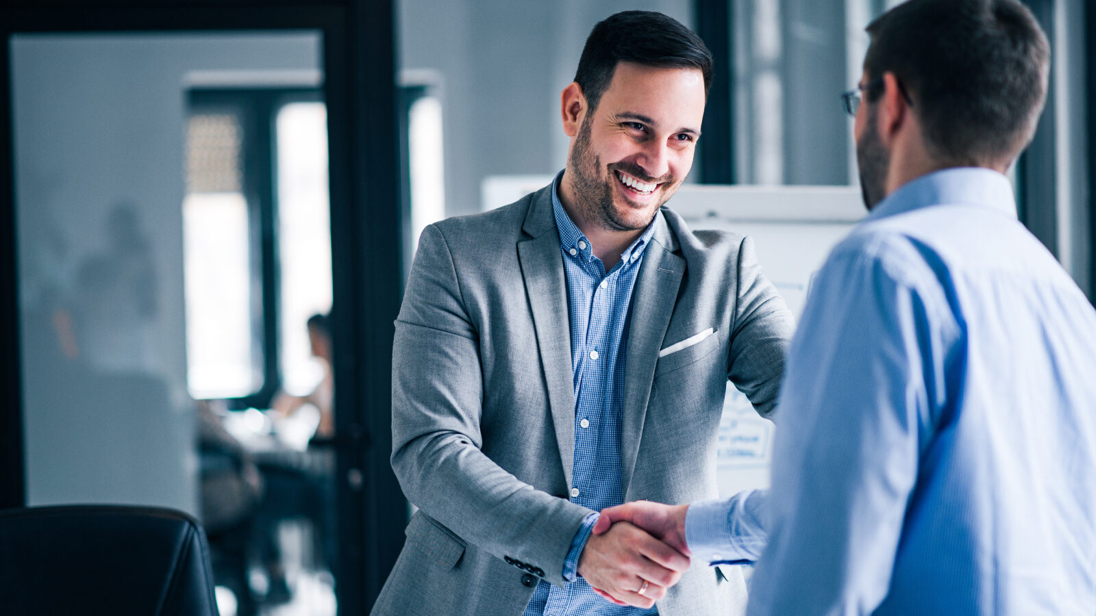 Two businessmen shake hands